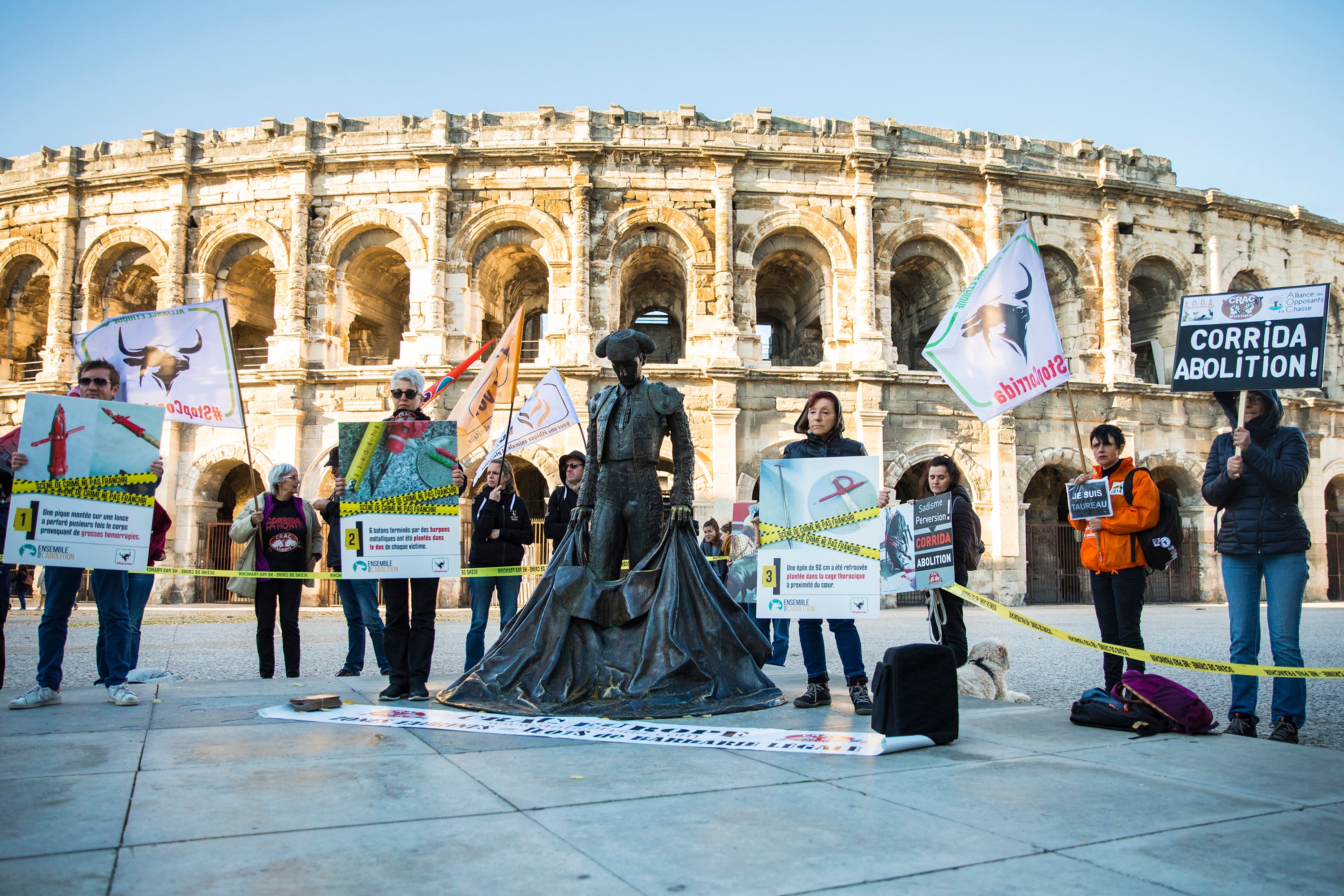 A small group of protesters gather outside the arena used for bullfighting in Nîmes