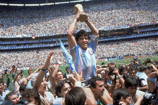 Diego Maradona with the trophy after the 1986 World Cup final (Carlo Fumagalli/AP/PA)