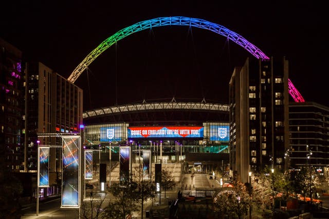 <p>The Wembley arch lit up over the stadium</p>