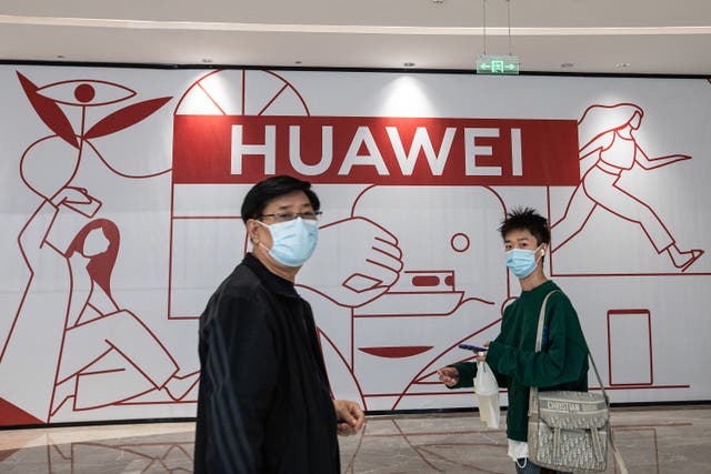 <p>Visitors walk past a Huawei store preparing to open at the Wushang Dream Plaza mall in Wuhan, China </p>