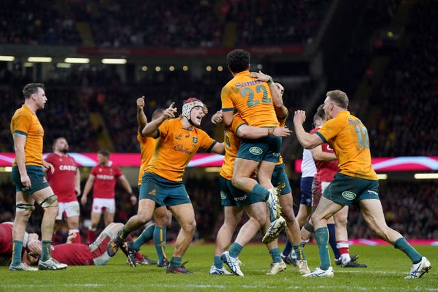 Australia players celebrate at the final whistle after a stunning comeback to beat Wales (Joe Giddens/PA)