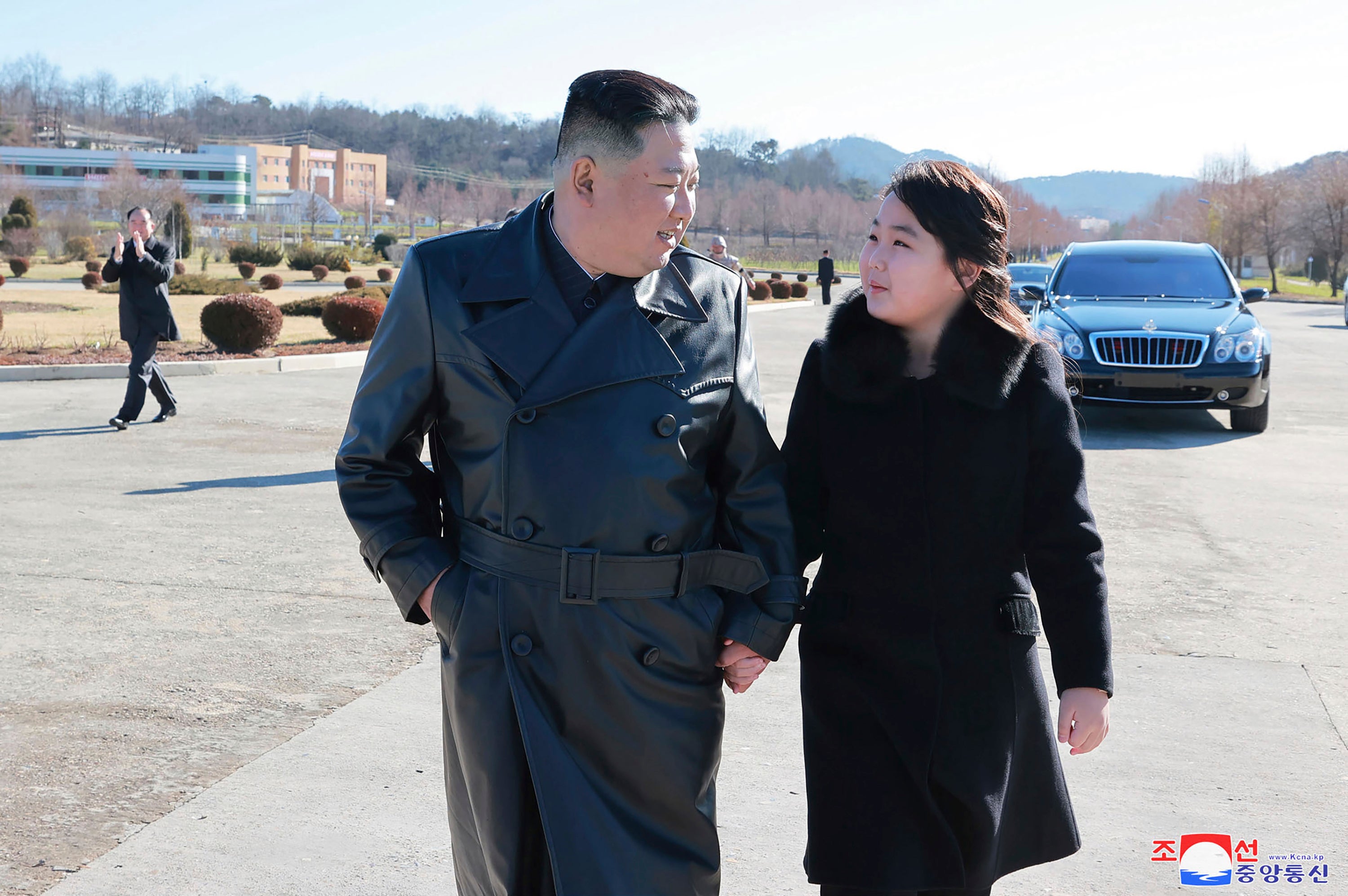 North Korean leader Kim Jong-un and his daughter seen following the launch of an intercontinental ballistic missile, at an unidentified location