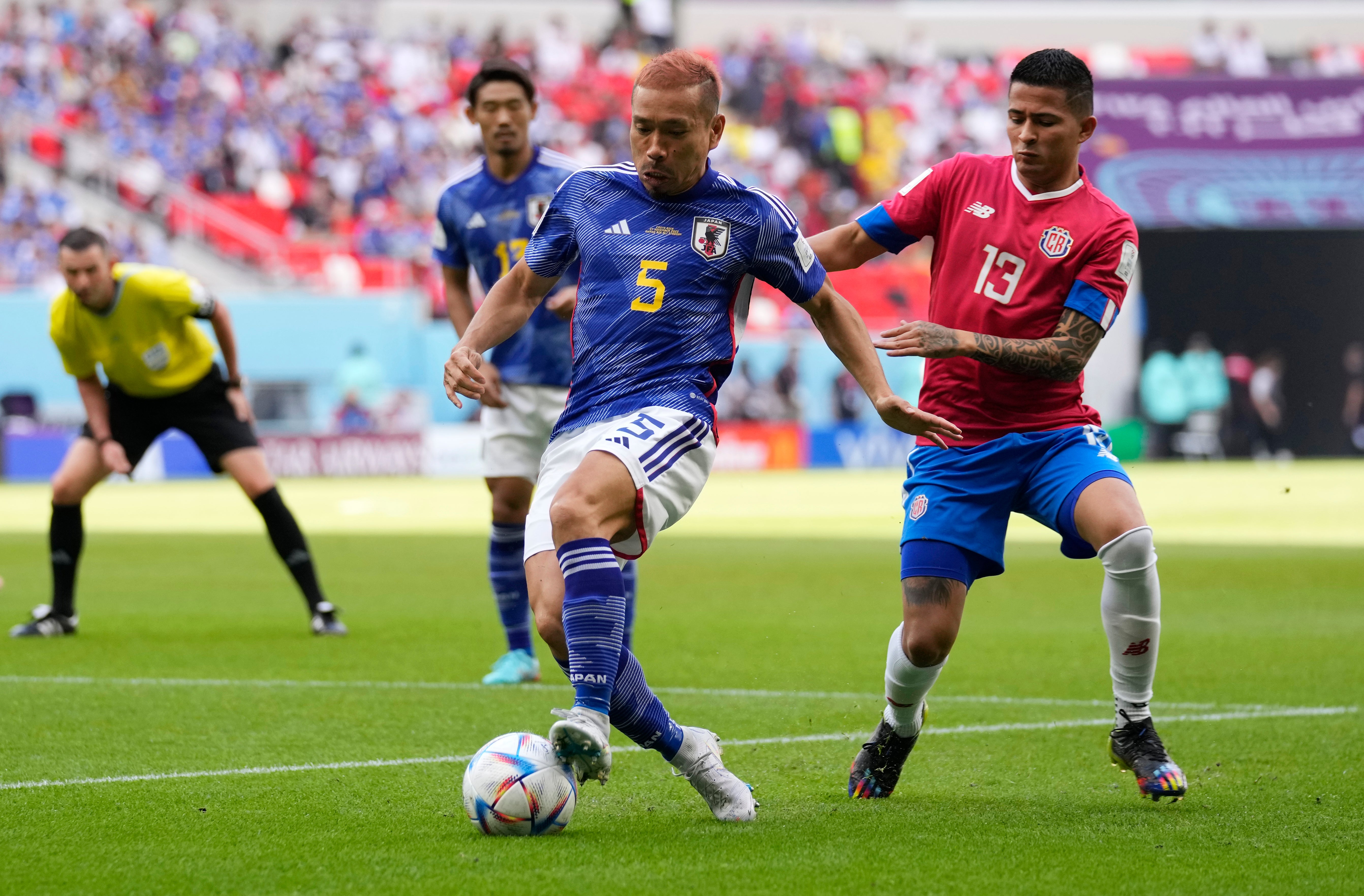 Japan's Yuto Nagatomo, left, is challenged by Costa Rica's Gerson Torres