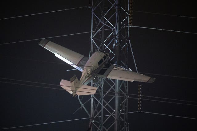 <p>A small one-engine plane seen rests on live power lines after crashing</p>