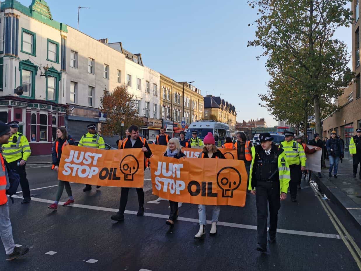 Just Stop Oil carried banners along the street in west London