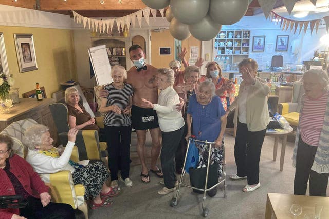 Residents at Kingsleigh care home with their ‘favourite’ butler in the buff, Alessandro (Care UK/PA)