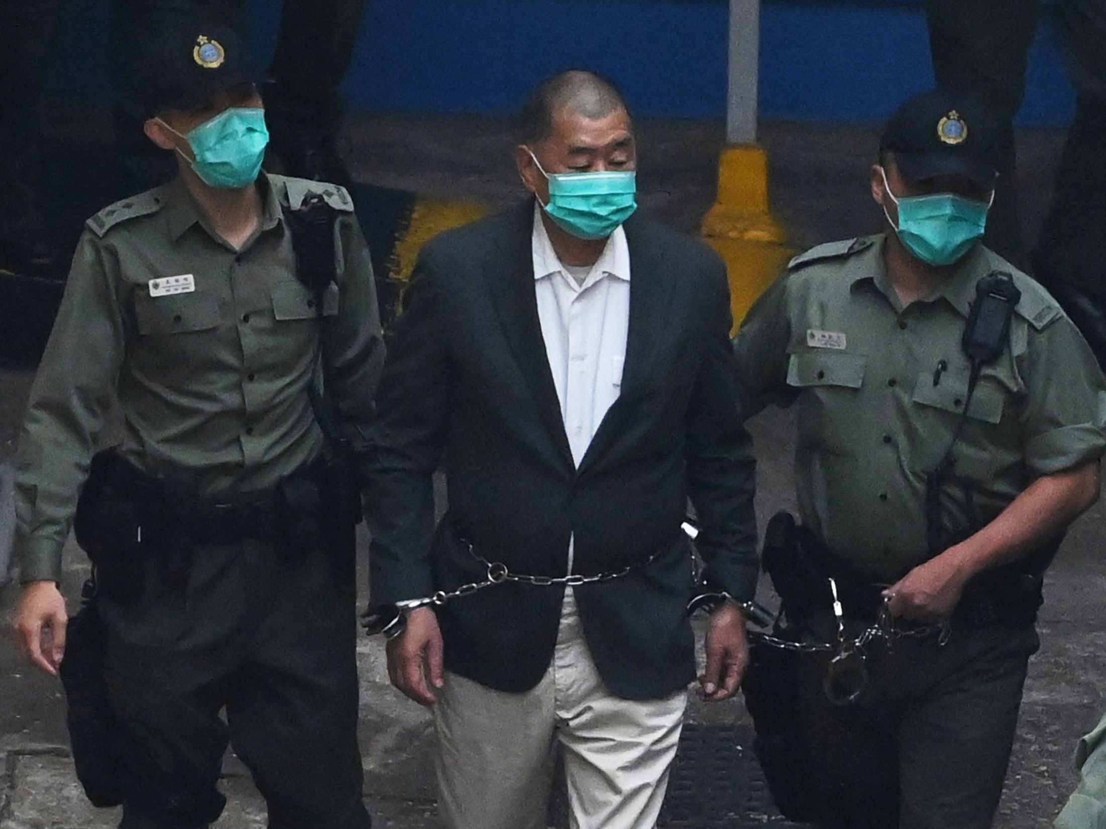 <p>Hong Kong pro-democracy media tycoon Jimmy Lai being led into a police van</p>