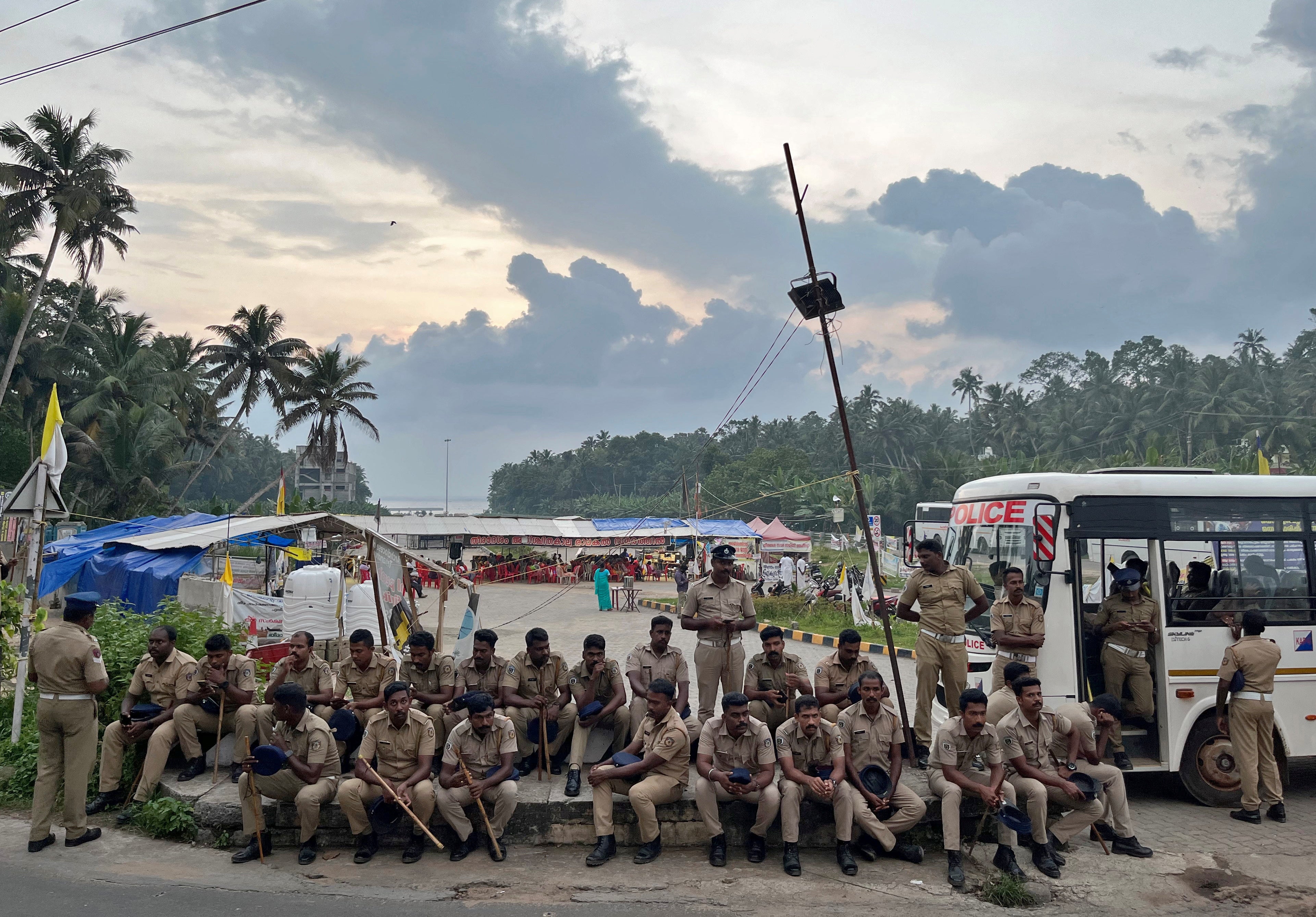 Police officers are deployed as fishermen protest near the entrance of the proposed Vizhinjam Port in Kerala