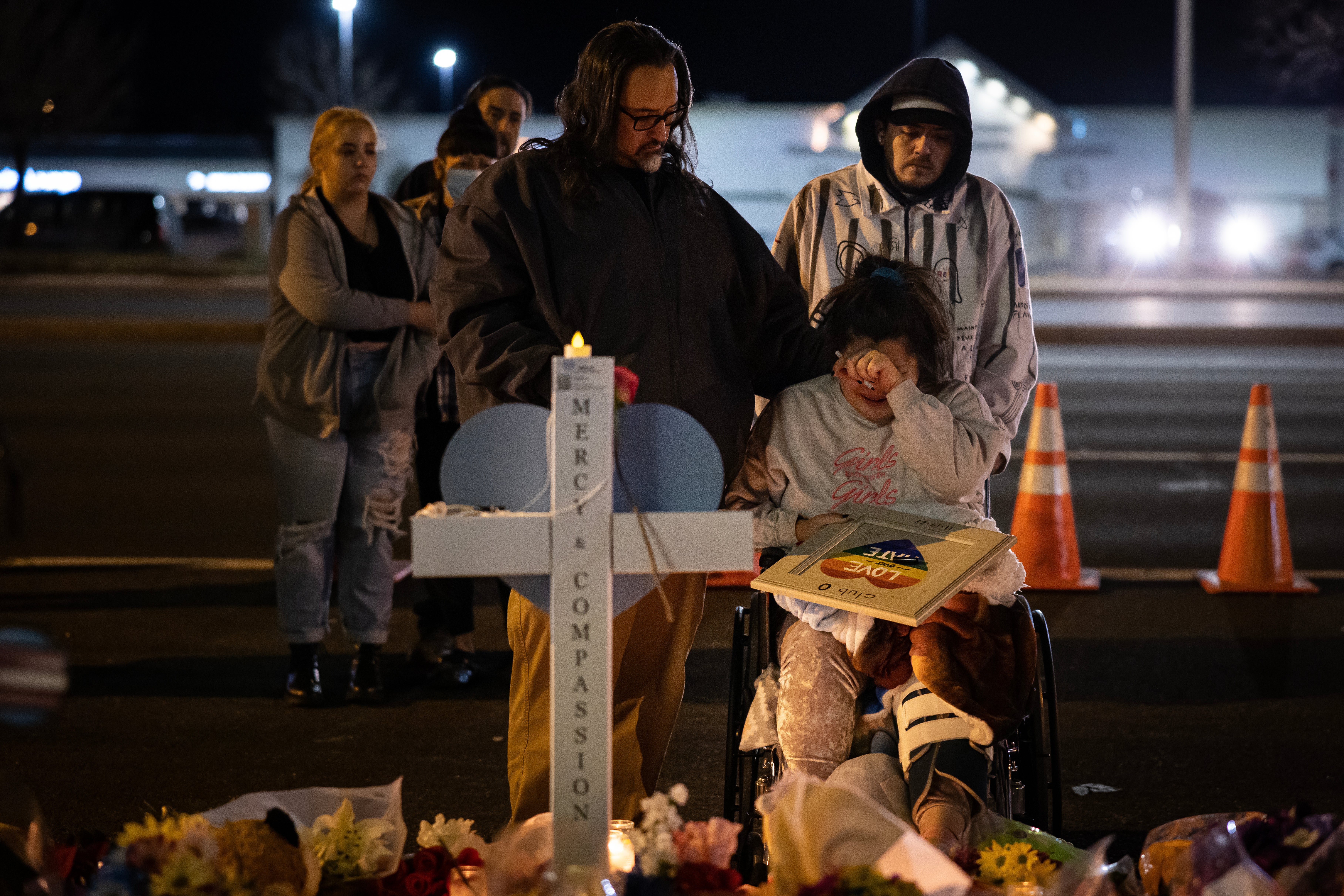 Richard Fierro consoles his daughter Kassandra on 22 November at a memorial for her boyfriend who was fatally shot during a mass shooting at Club Q in Colorado Springs.