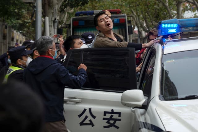 <p>A protester is arrested during a street protest in Shanghai on Sunday</p>