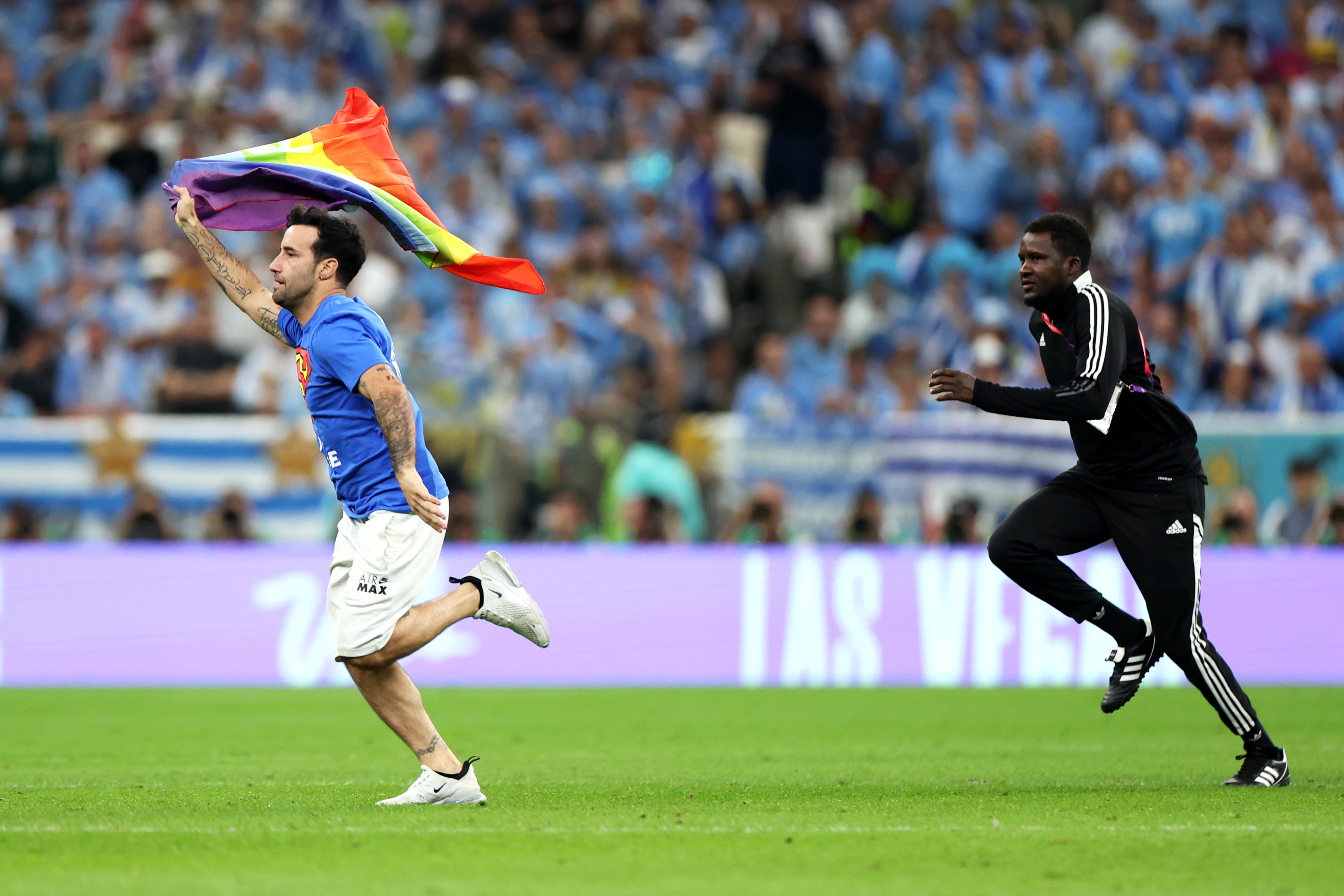 World Cup 2022 pitch invader wears 'Save Ukraine' shirt and holds pride  flag during Portugal vs Uruguay