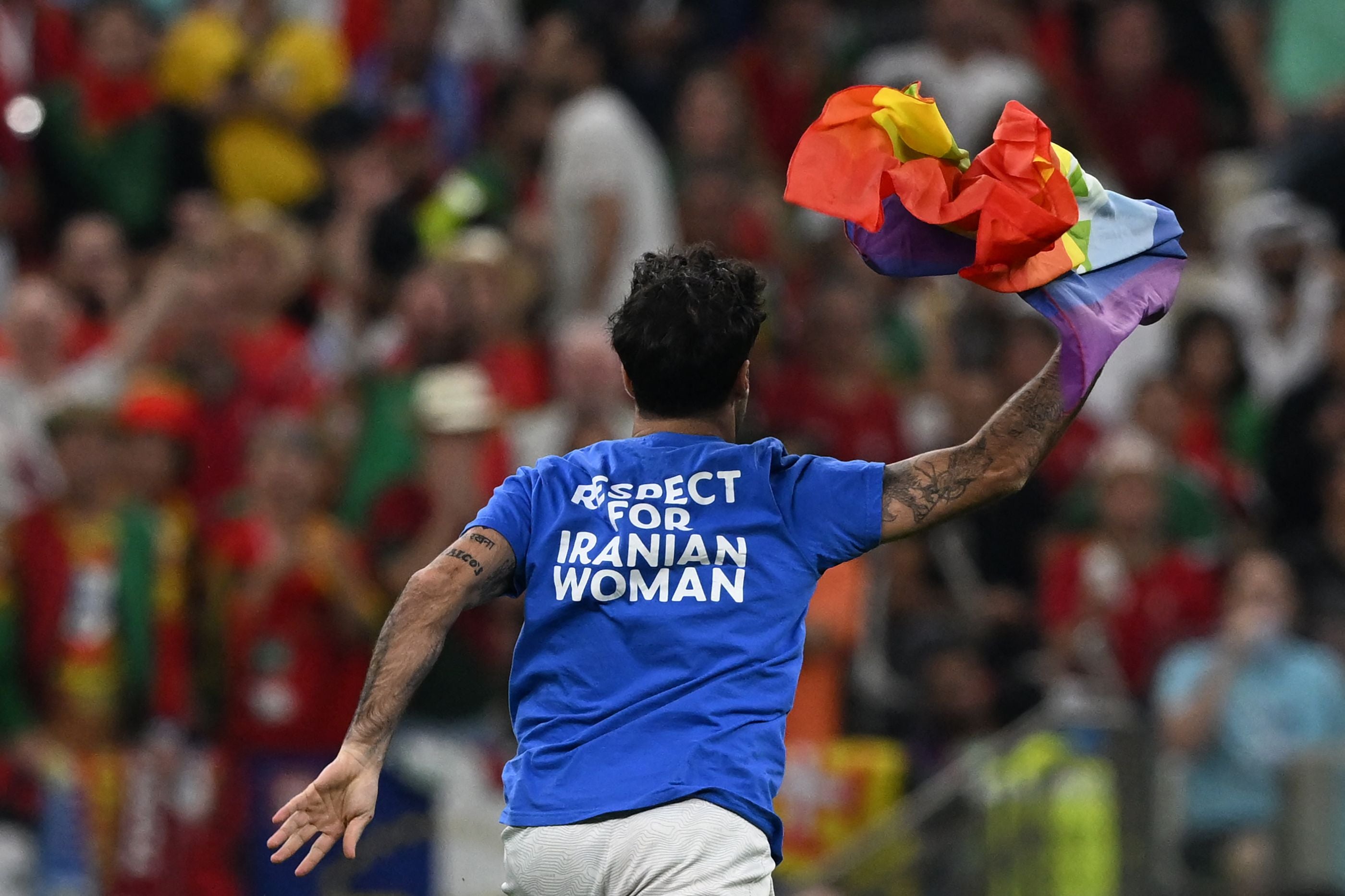 Portugal vs. Uruguay: Pitch invader with rainbow flag interrupts