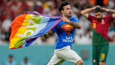 Pitch invader waving pride flag tackled after storming World Cup match