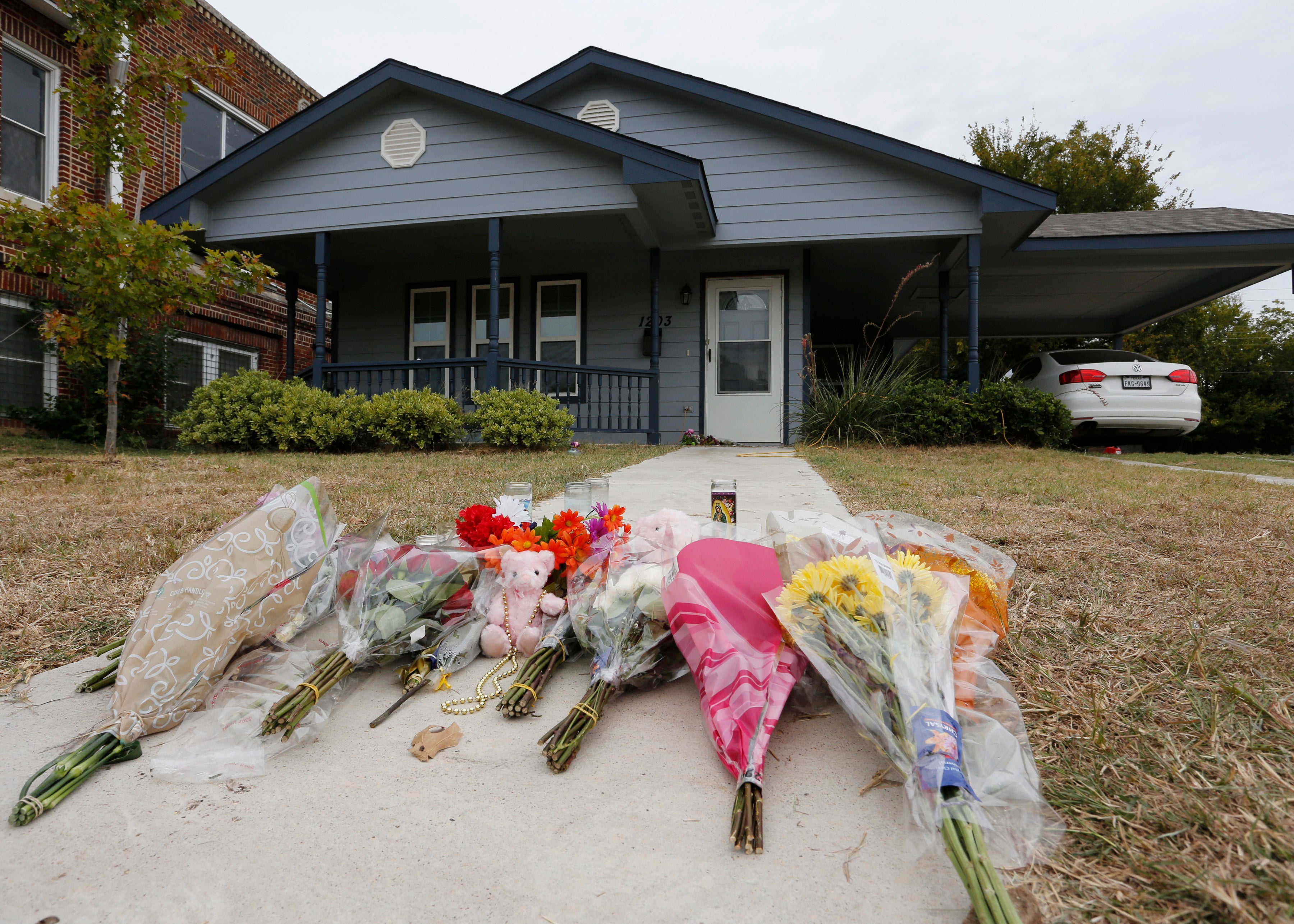 Flowers lie on the sidewalk in front of the house in Fort Worth, Texas, where a white Fort Worth police officer Aaron Dean shot and killed Atatiana Jefferson, a black woman, through a back window of her home