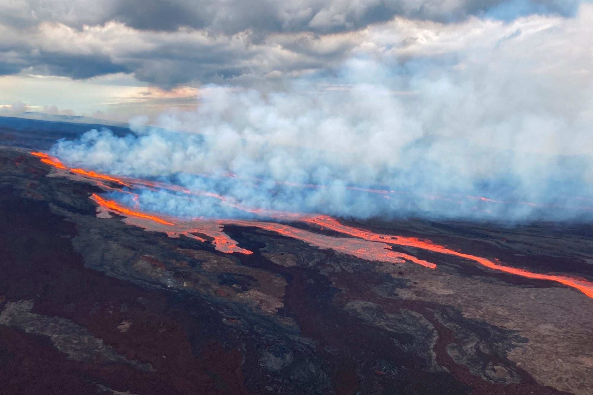 In this aerial photo released by the US Geological Survey, the Mauna Loa volcano is seen erupting from vents on the Northeast Rift Zone on the Big Island of Hawaii, on Monday