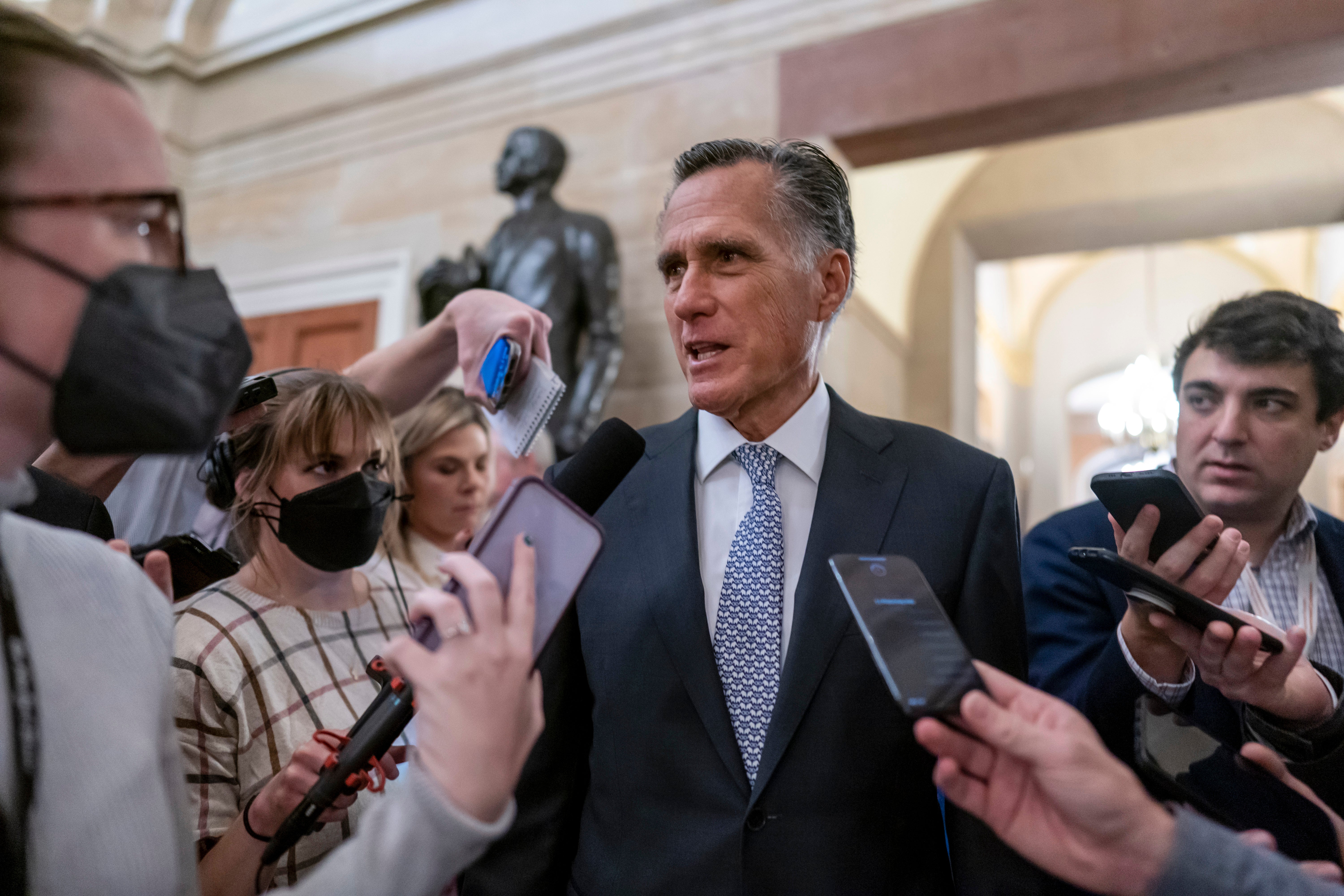 File Mitt Romney, R-Utah, is surrounded by reporters as he arrives at the historic Old Senate Chamber at the Capitol in Washington