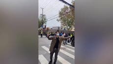 Bouquet-holding protester dragged away at anti-lockdown rally in China
