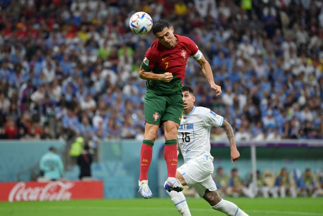 <p>Cristiano Ronaldo attempts to head the ball towards goal</p>