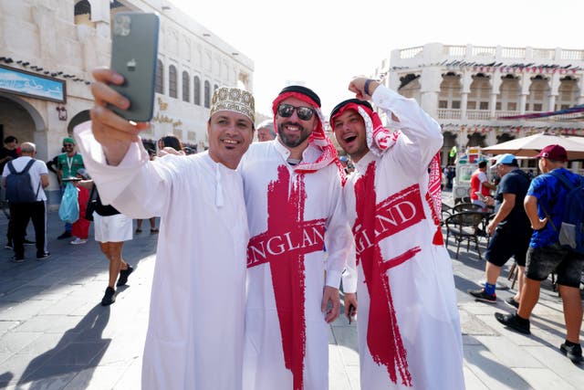 England fans pose for a photograph at a souq in Doha on the day of the FIFA World Cup Group B match between Wales and England (Nick Potts/PA)