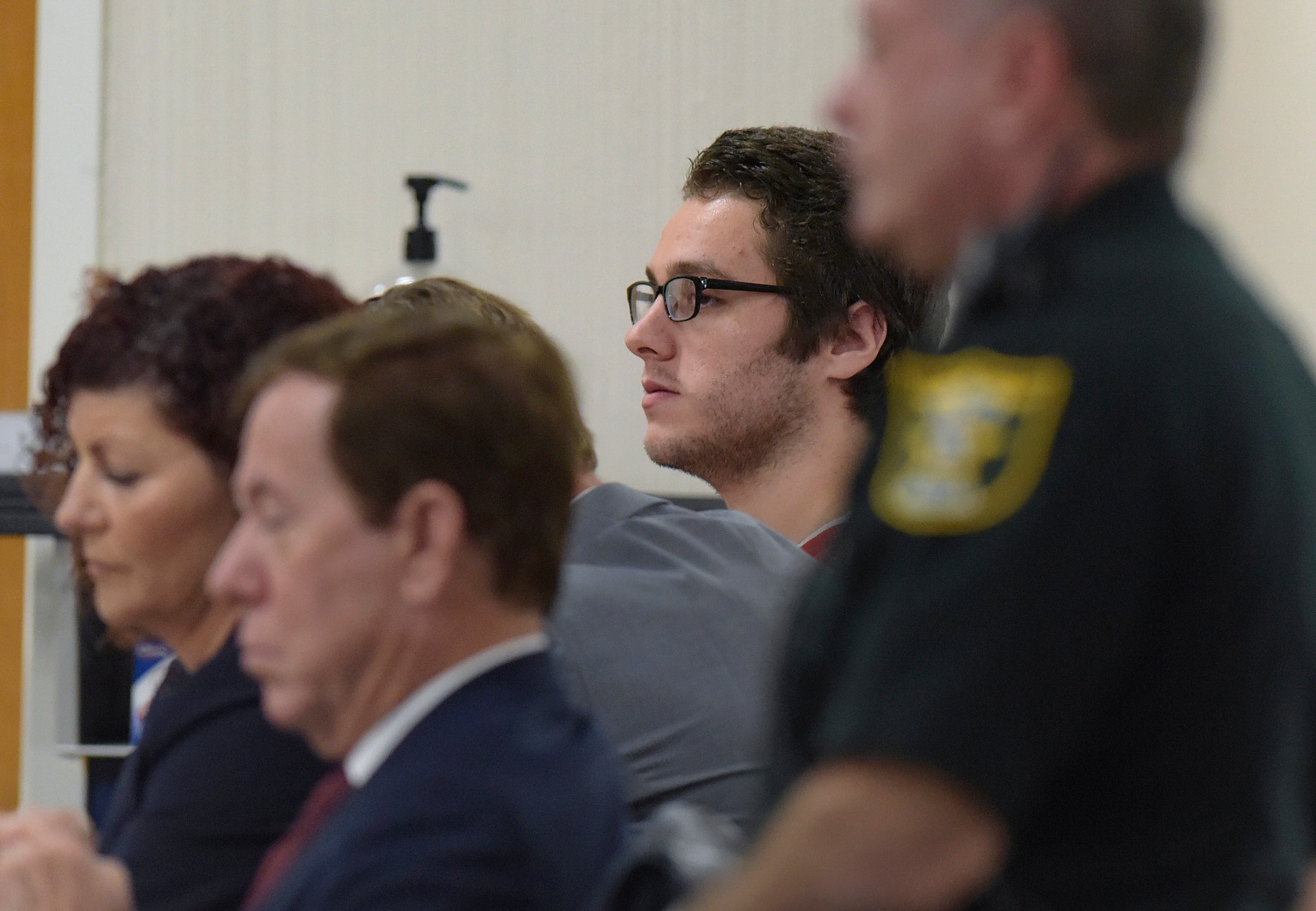 Austin Harrouff, in back, sits with his legal team in court before Circuit Judge Sherwood Bauer at the Martin County Courthouse.