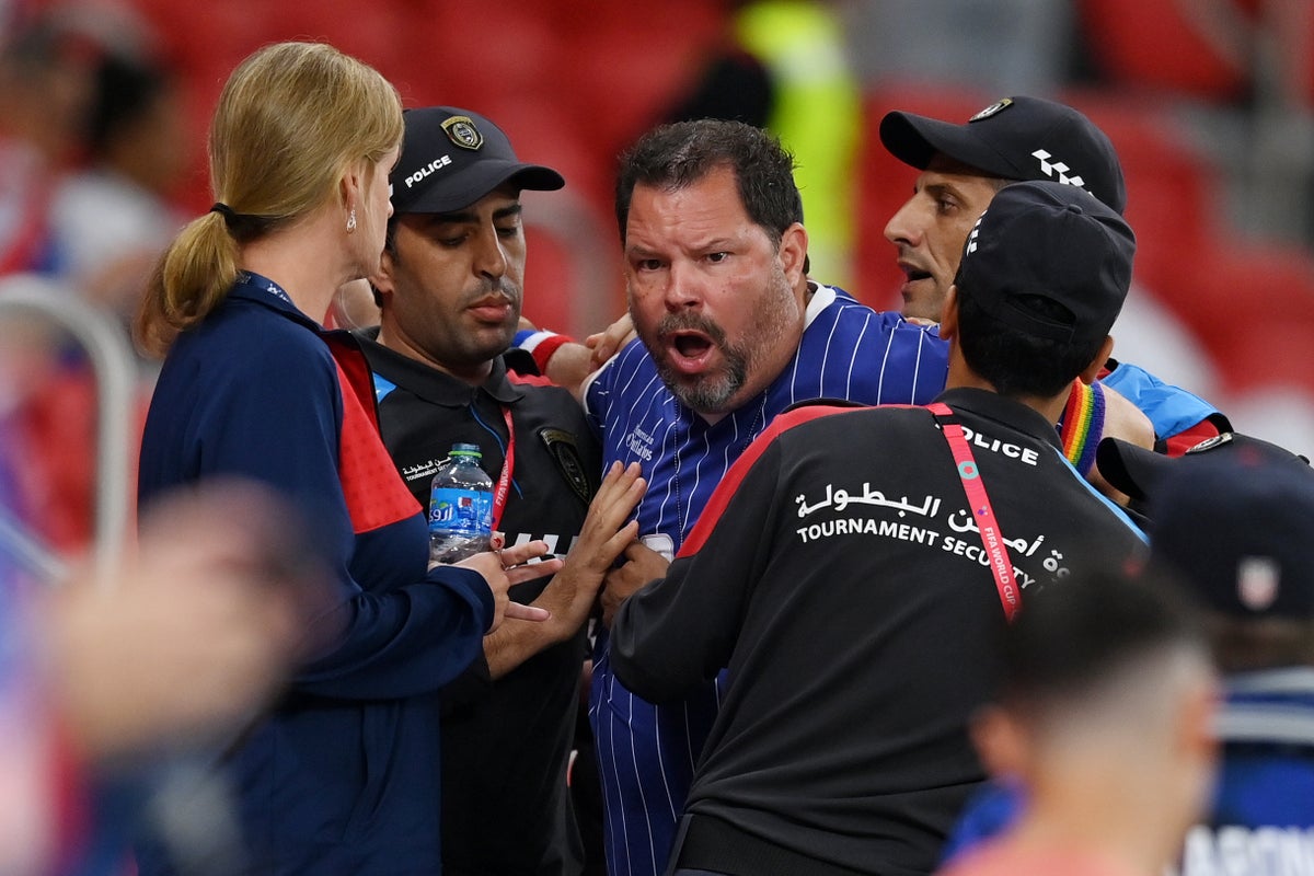 Photos show USA fan seized by Qatar police for wearing rainbow armband to World Cup game