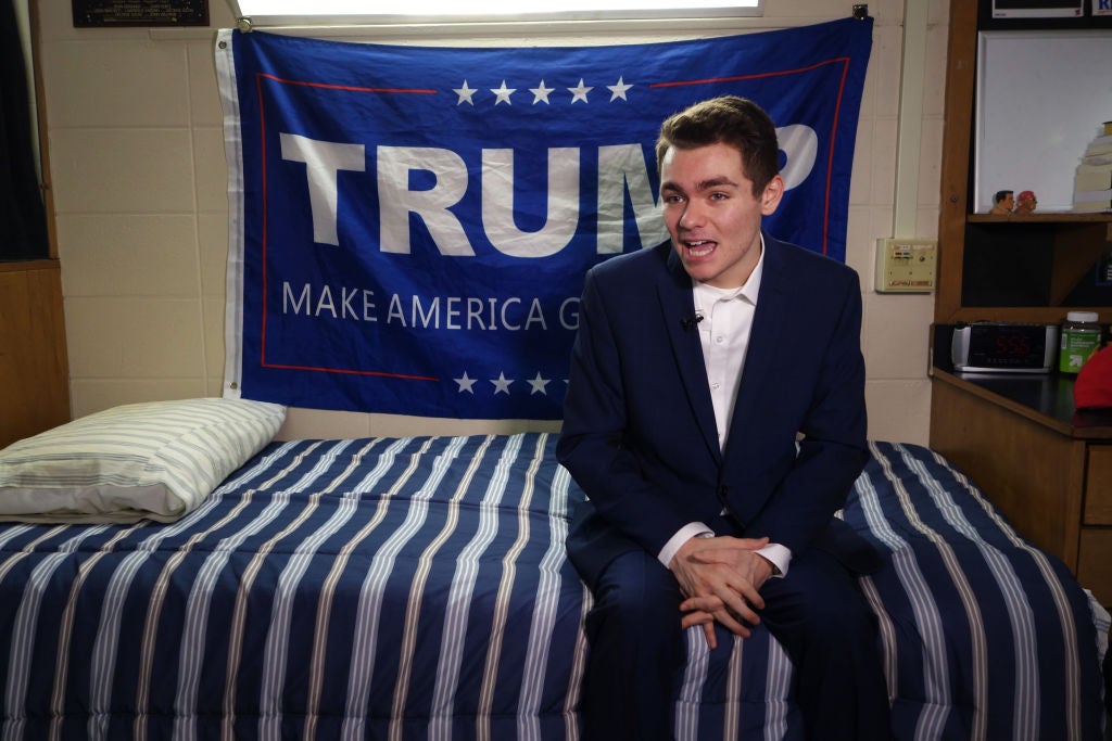 White nationalist Nick Fuentes poses in his dorm room in 2016