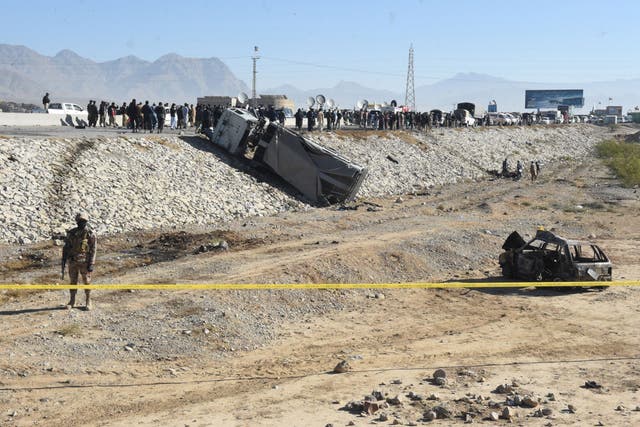 <p>A security official stands guard at the site of a suicide bomb attack targeting a police truck in Quetta on 30 November 2022</p>
