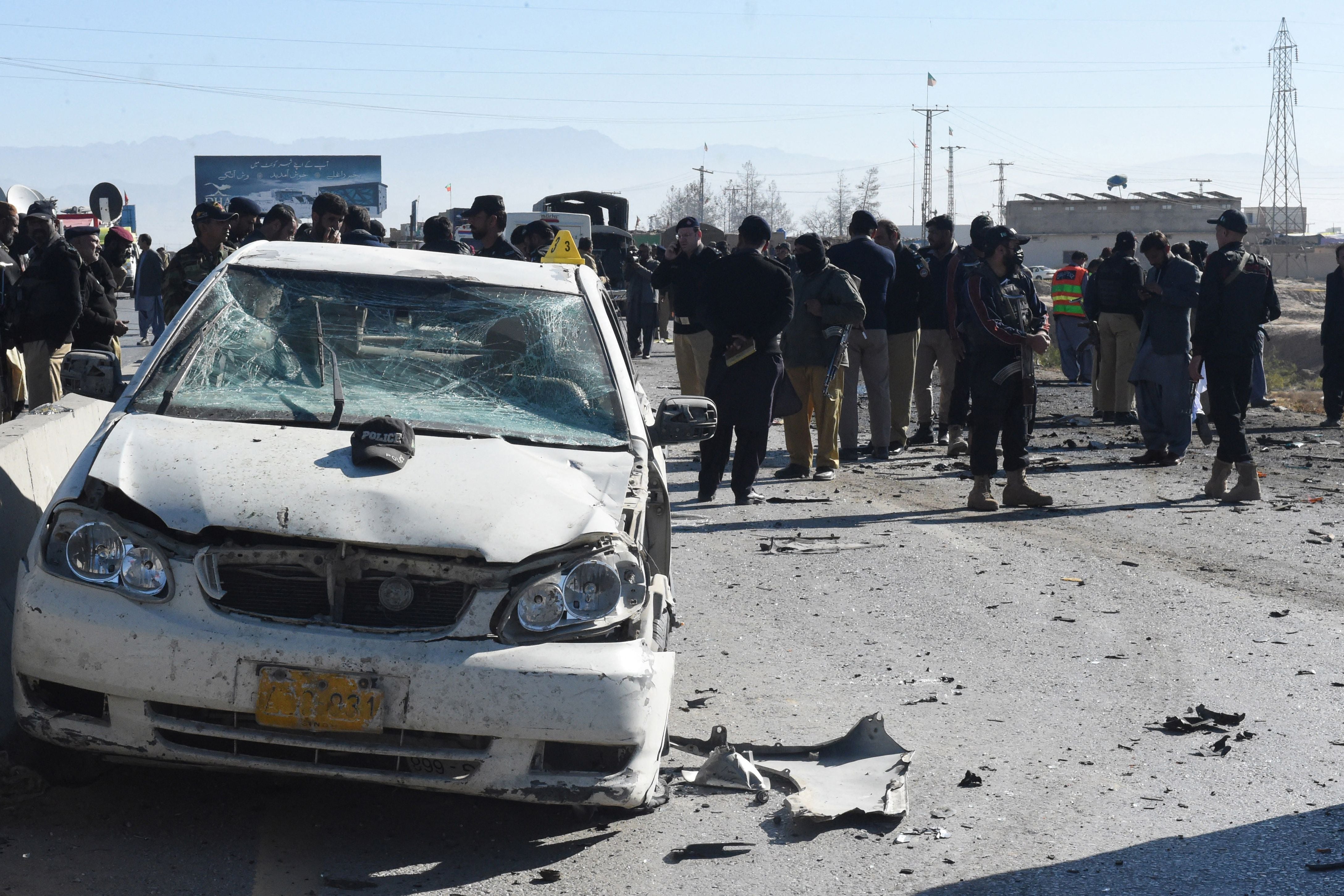 Security officials gather at the site of a suicide bomb attack targeting a police truck in Quetta on 30 November