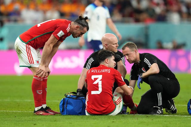 Wales defender Neco Williams receives treatment before leaving the pitch with a head injury against England (Martin Rickett/PA)