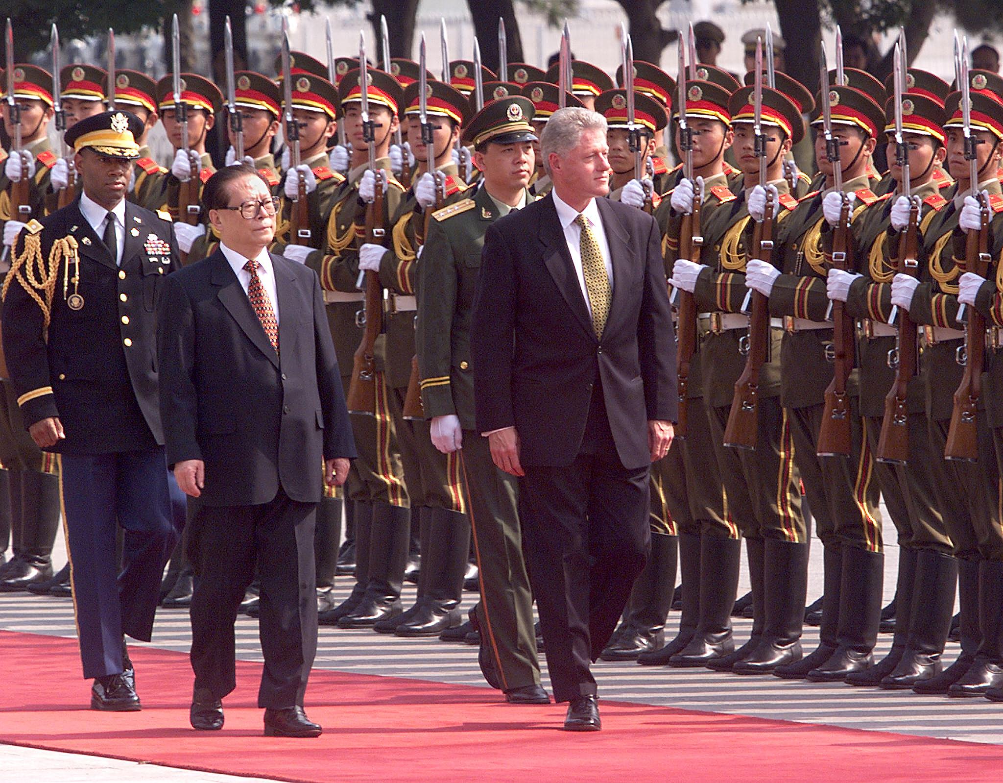 Bill Clinton and Jiang Zemin inspect Chinese troops during a state arrival ceremony in the East Plaza of the Great Hall of the People in Beijing