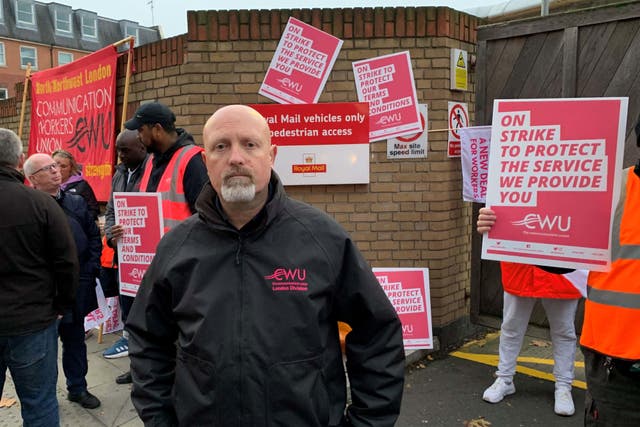 Mark Dolan, London divisional representative for the CWU with striking postal workers outside the Royal Mail Islington Delivery Office in north London (Lucas Cumiskey/PA)