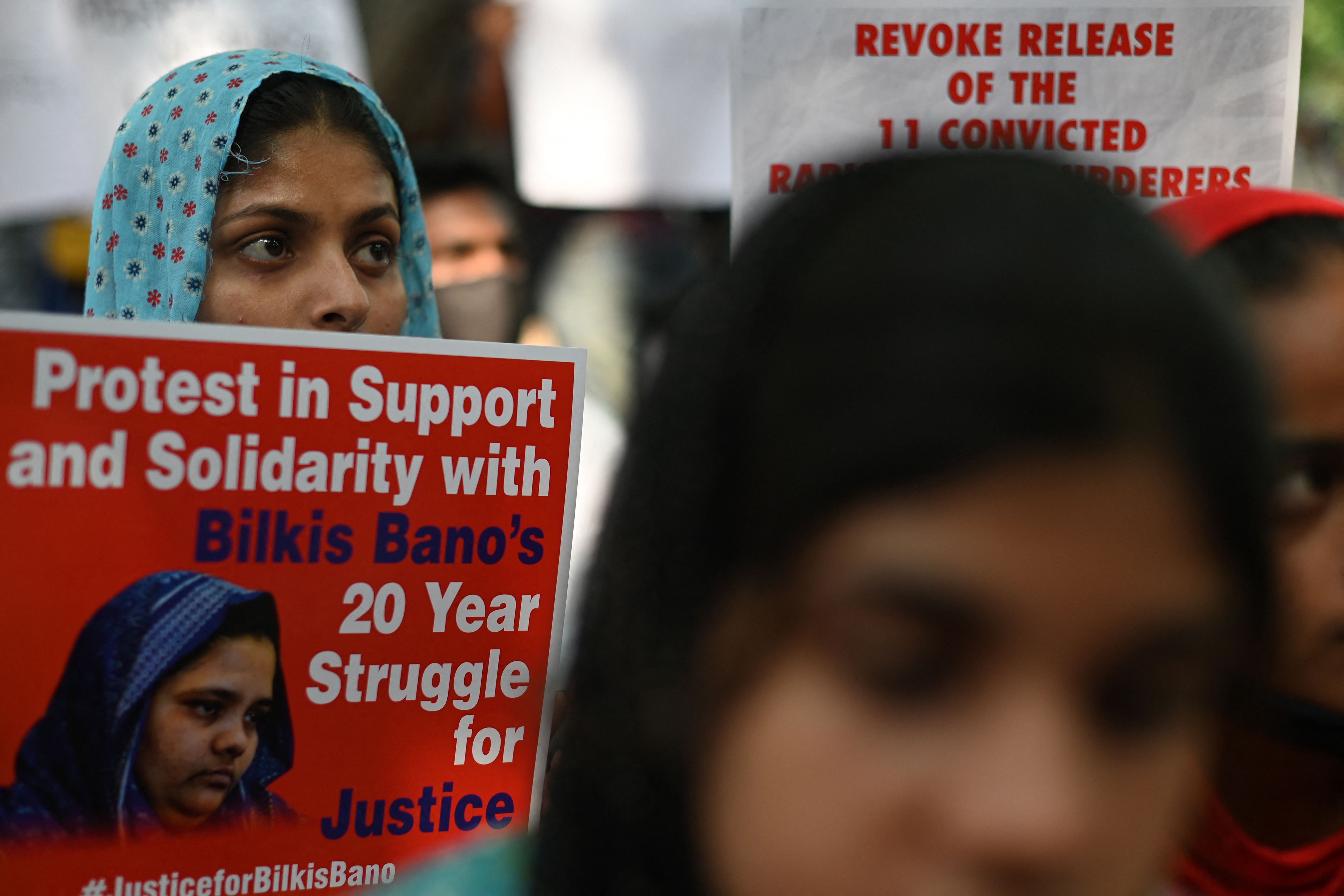 File. Demonstrators hold placards during a protest against the release of men convicted of gang-raping of Bilkis Bano during the 2002 communal riots in Gujarat, in New Delhi on 27 August 2022