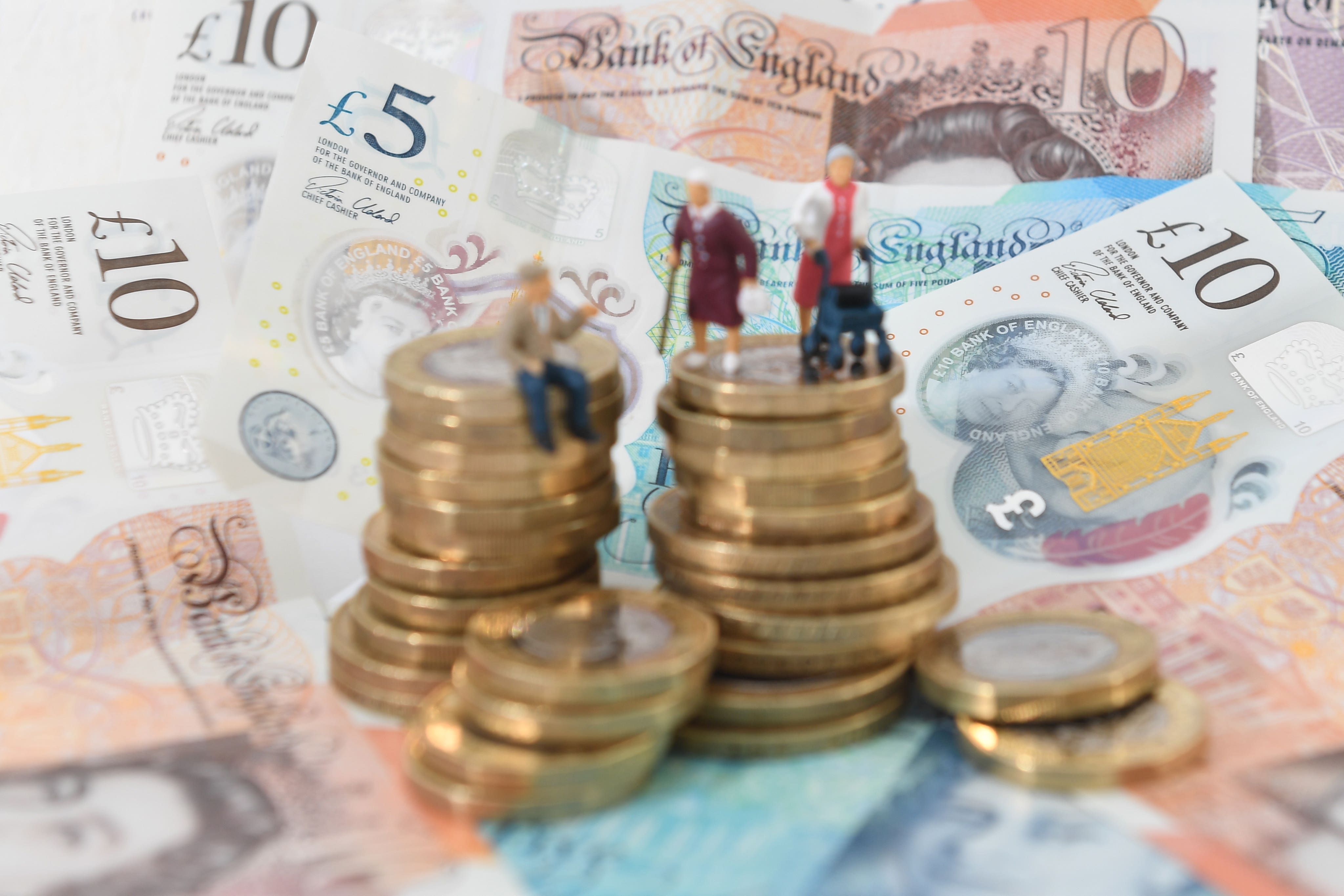 File photo dated 12/09/18 of models of elderly people on a pile of coins and bank notes. (Joe Giddens/PA)