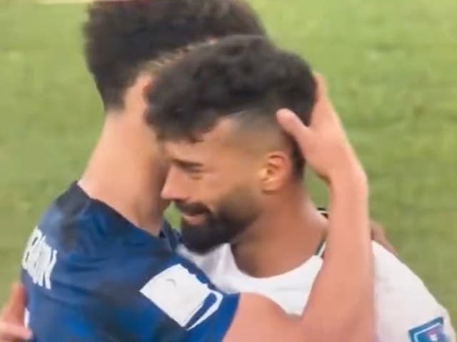<p>US football player Antonee Robinson hugs Iran’s Ramin Rezaian after the US’s 1-0 win</p>