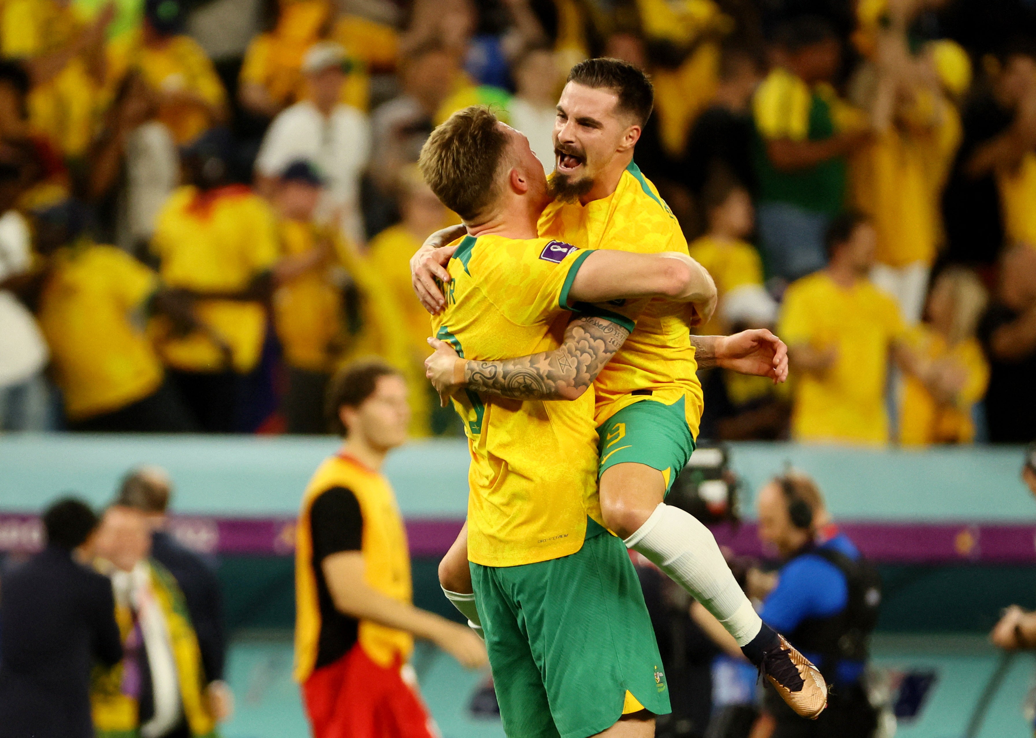 Australian players celebrate their dramatic victory over Denmark