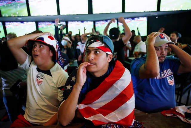 <p>US fans react as Iran and the USA face off in the FIFA World Cup 2022 group B soccer match, at a bar in Los Angeles, California, USA,</p>