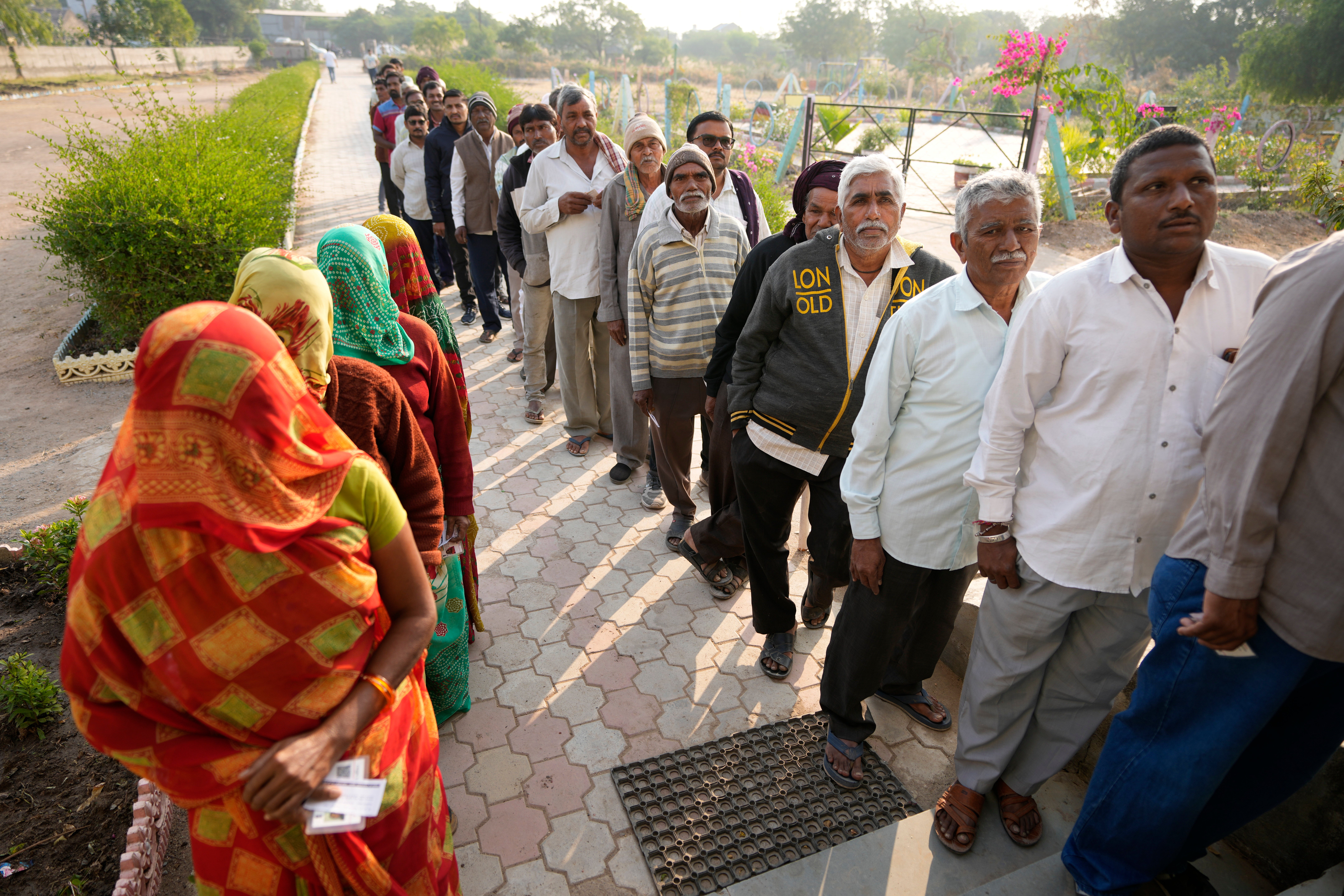 File photo: People stand in queue to cast their votes during the first phase of Gujarat state legislature elections in Limbadi, India in December 2022