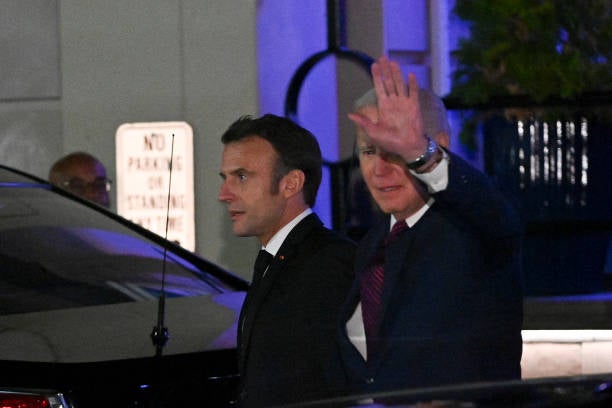 US president Joe Biden waves as he and French president Emmanuel Macron leave Fiola Mare restaurant after a private dinner in Washington, DC, on 30 November 2022