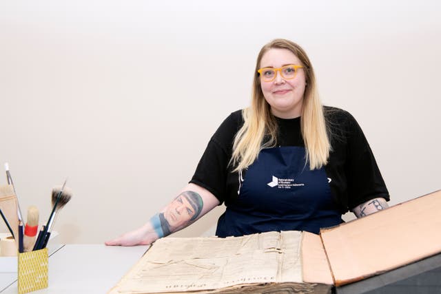 Claire Hutchison works to conserve newspapers (Alison Gibson/National Library of Scotland/PA)