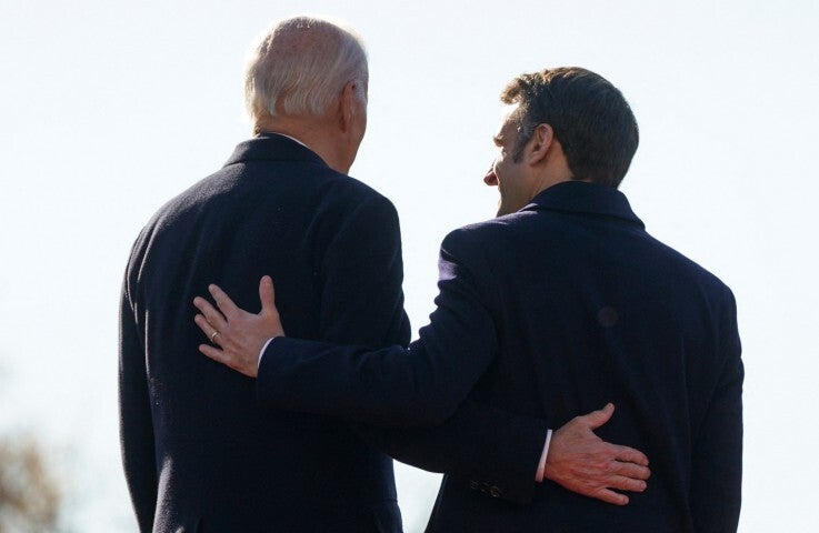 U.S. President Joe Biden and France's President Emmanuel Macron put their hands on each other's backs during an official State Arrival Ceremony for Macron on the South Lawn at the White House in Washington, U.S., December 1, 2022