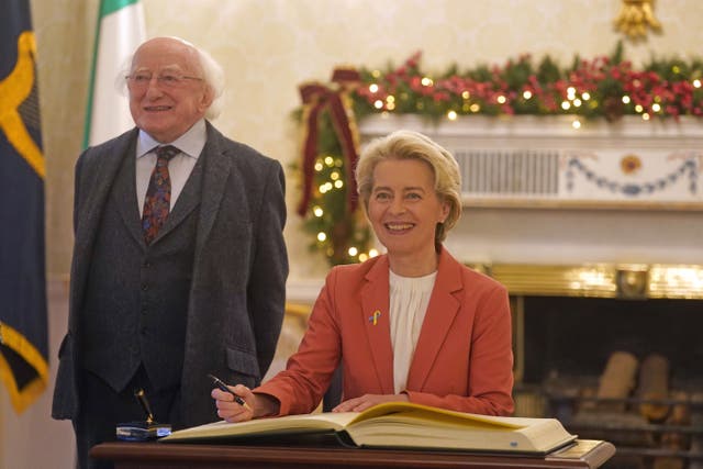 European Commission President Ursula von der Leyen signs the distinguished guests book as she meets President Michael D Higgins at Houses of Oireachtas in Dublin (Brian Lawless/PA)