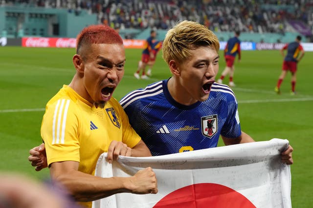 <p>Japan’s Ritsu Doan and Yuto Nagatomo (left) celebrate after the final whistle</p>
