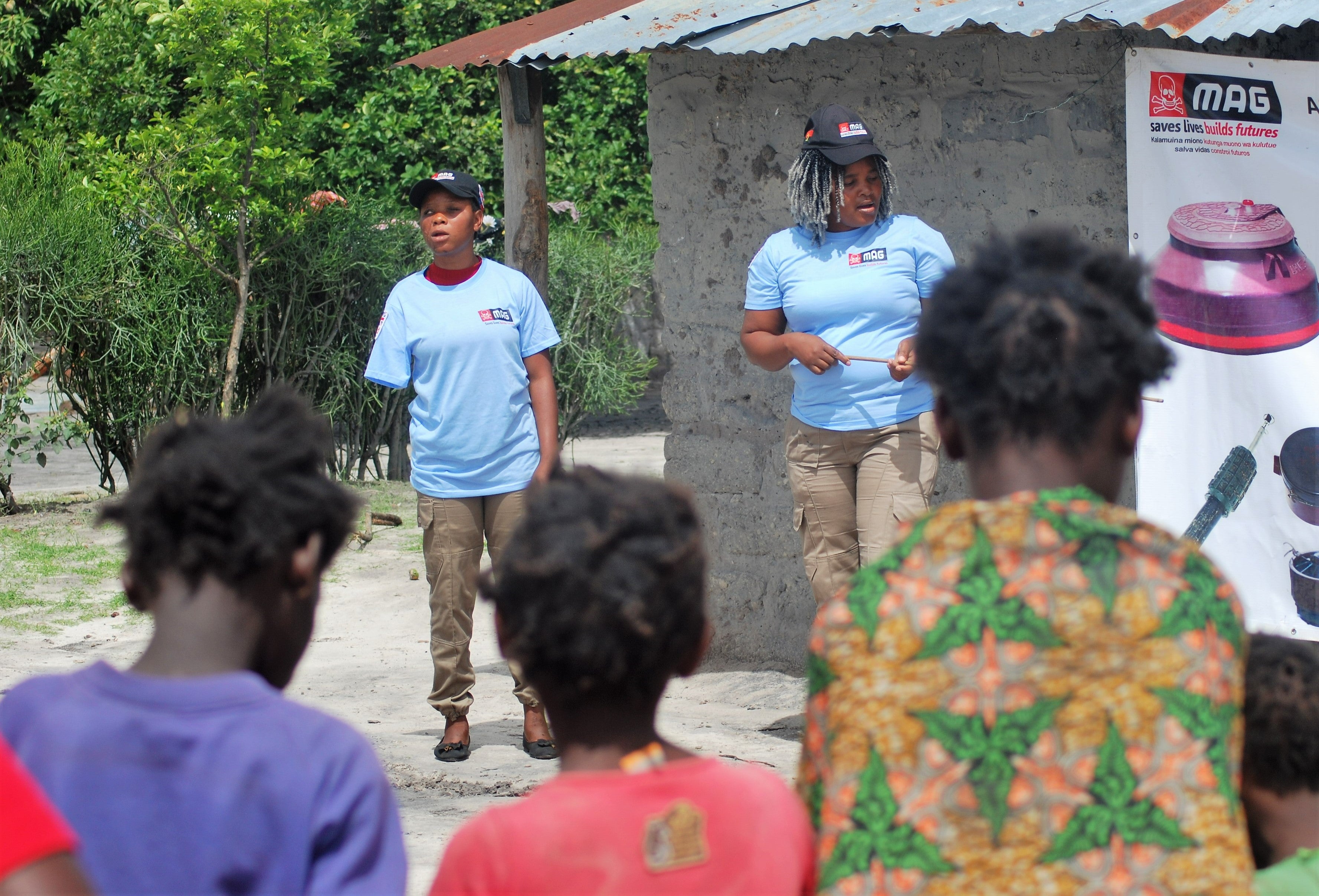 Today, Minga (left) is one of MAG’s risk education specialists travelling around villages to teach of the hazards landmines pose