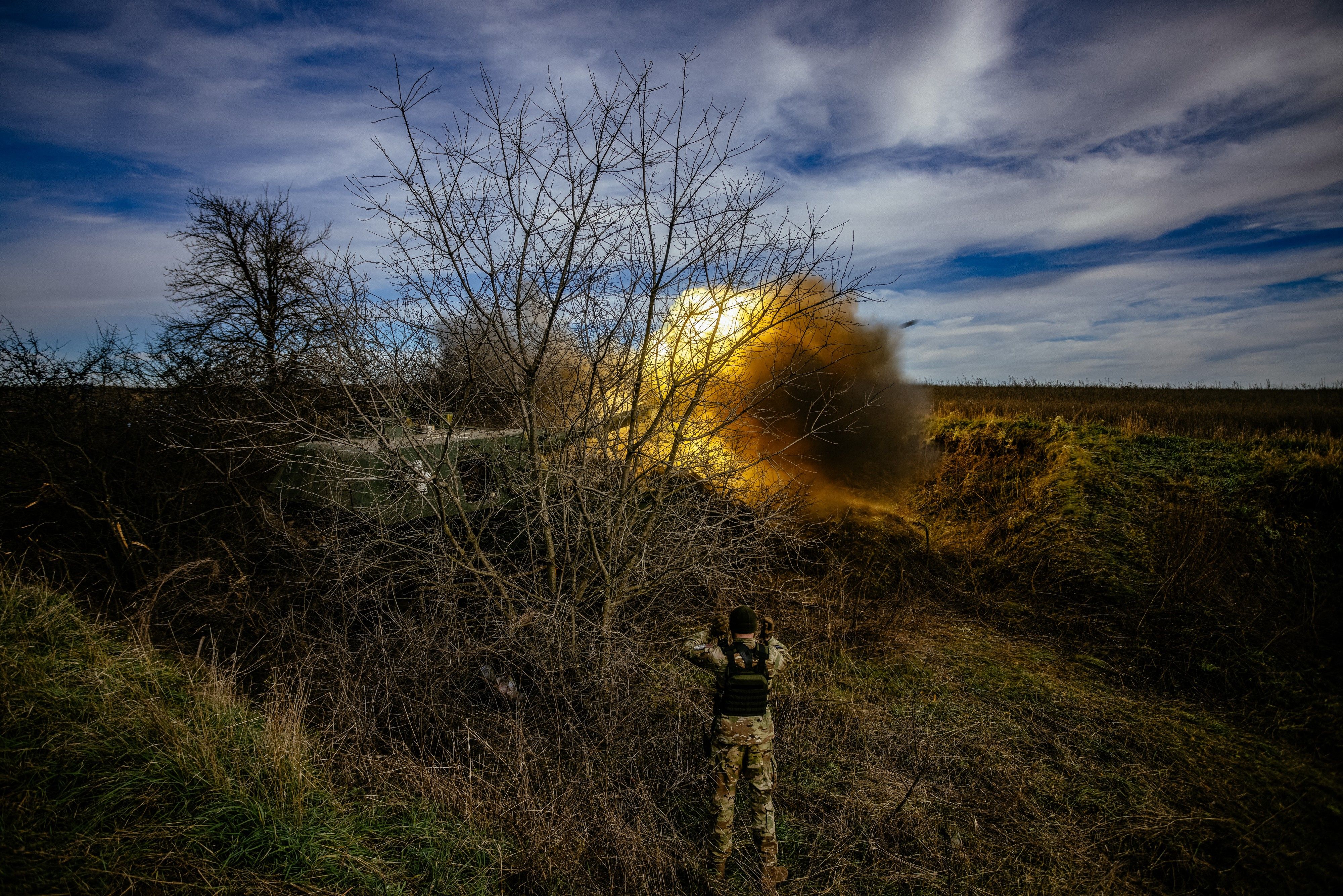 A howitzer fires towards Russian positions in a field near an undisclosed frontline position in eastern Ukraine