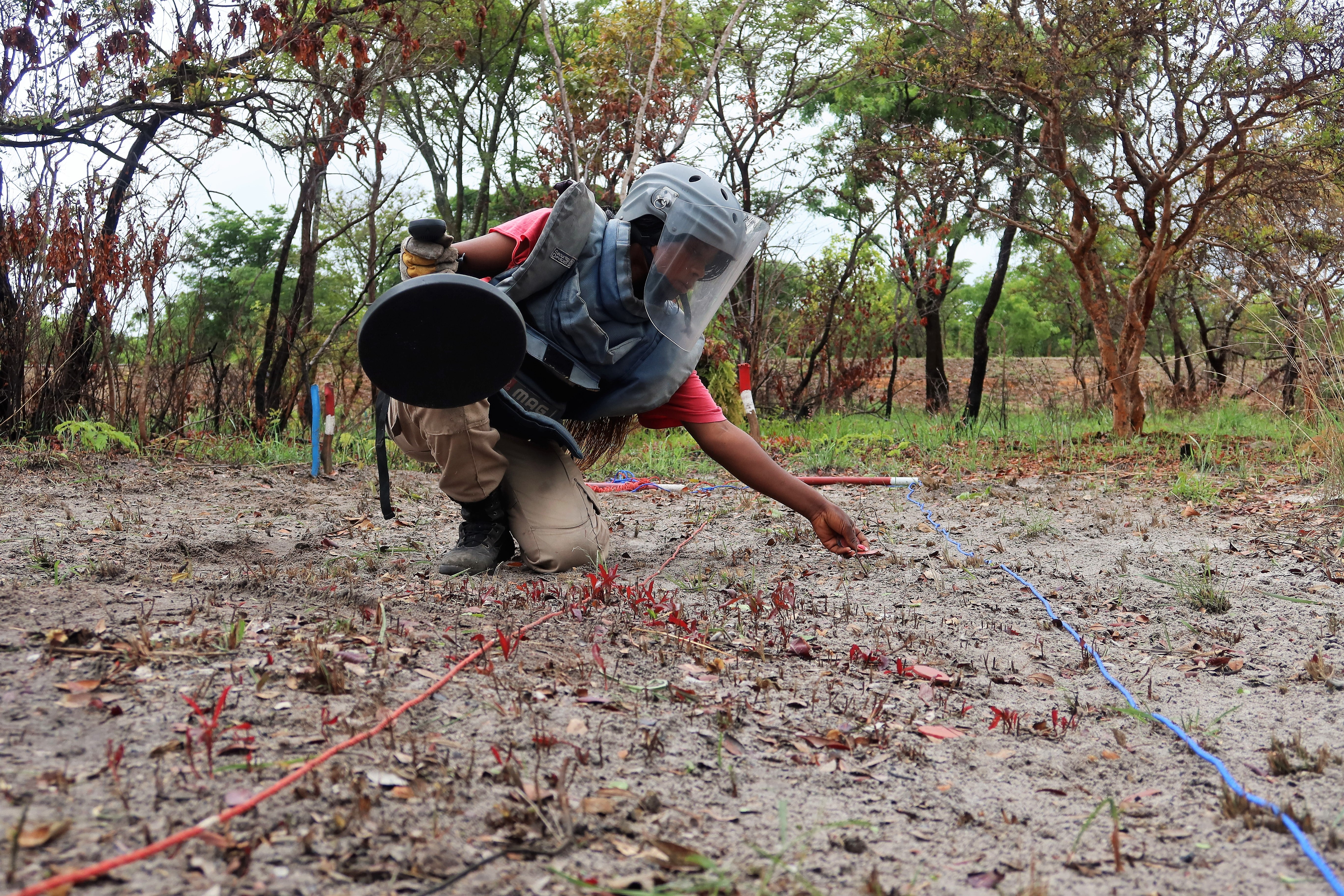 A MAG deminer in Angola searches for unexploded ordinance