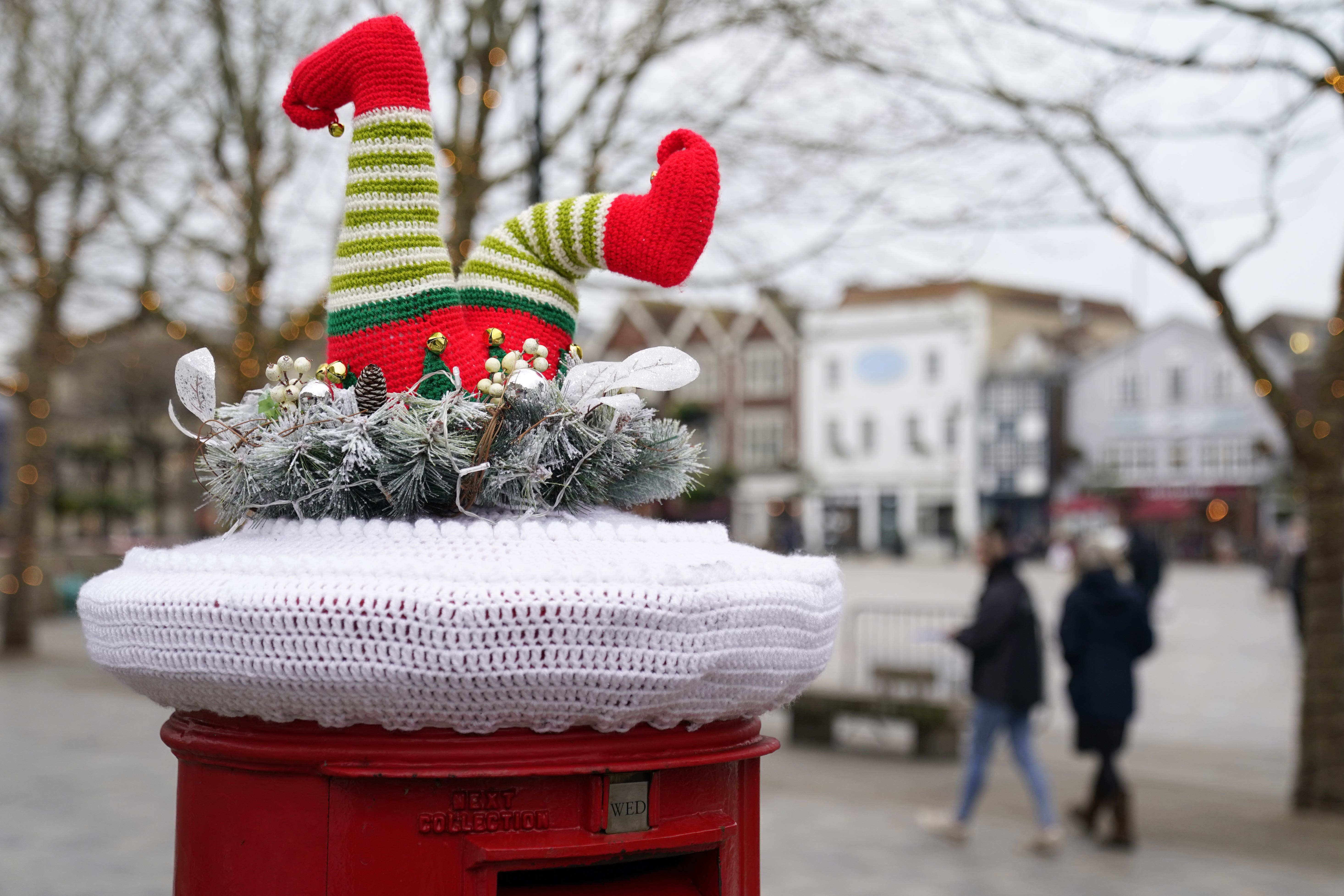 A festive yarn bomb on the top of a Royal Mail post box in Salisbury, Wiltshire. The advice this year is to post early (PA)