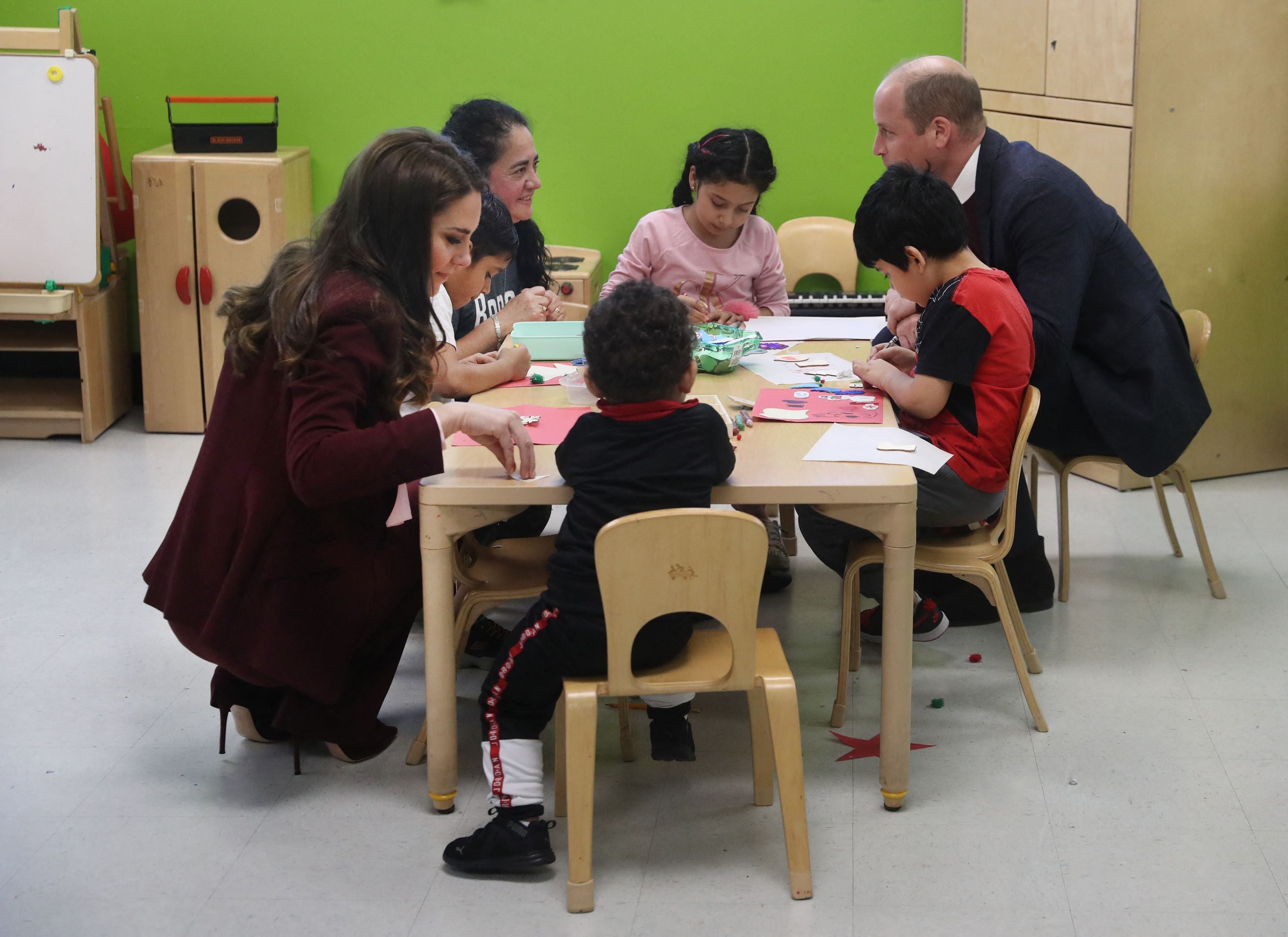 Britain’s Prince William, Prince of Wales, and Catherine, Princess of Wales, engage with children in the Young Mothers program during a visit to Roca Inc