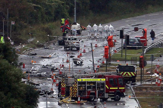 Emergency services on the A27 at Shoreham in West Sussex where seven people died when an historic Hawker Hunter fighter jet plummeted on to the major south coast road (PA)