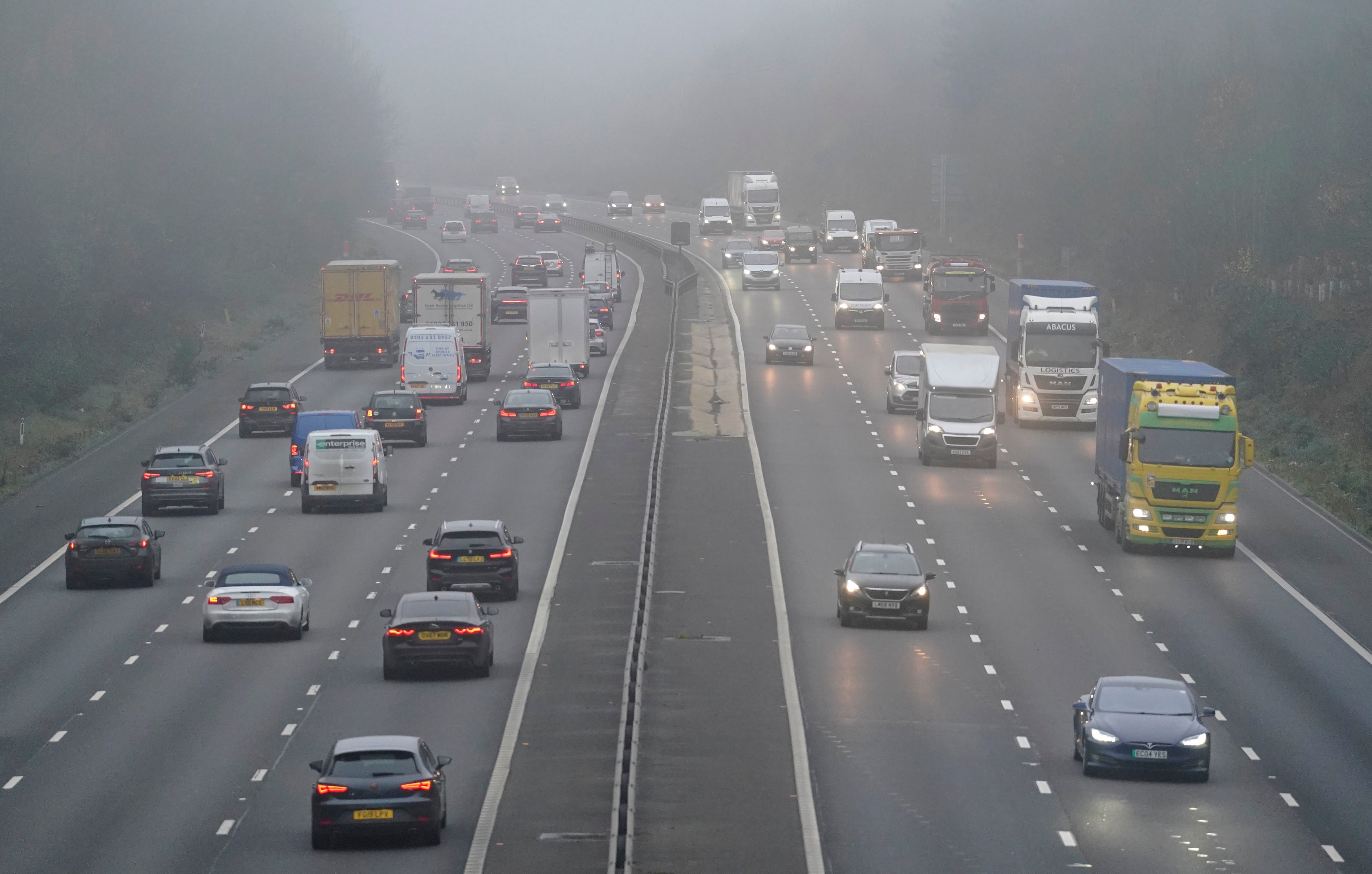 Vehicles drive through fog on the M3 near Old Basing in Hampshire on Friday