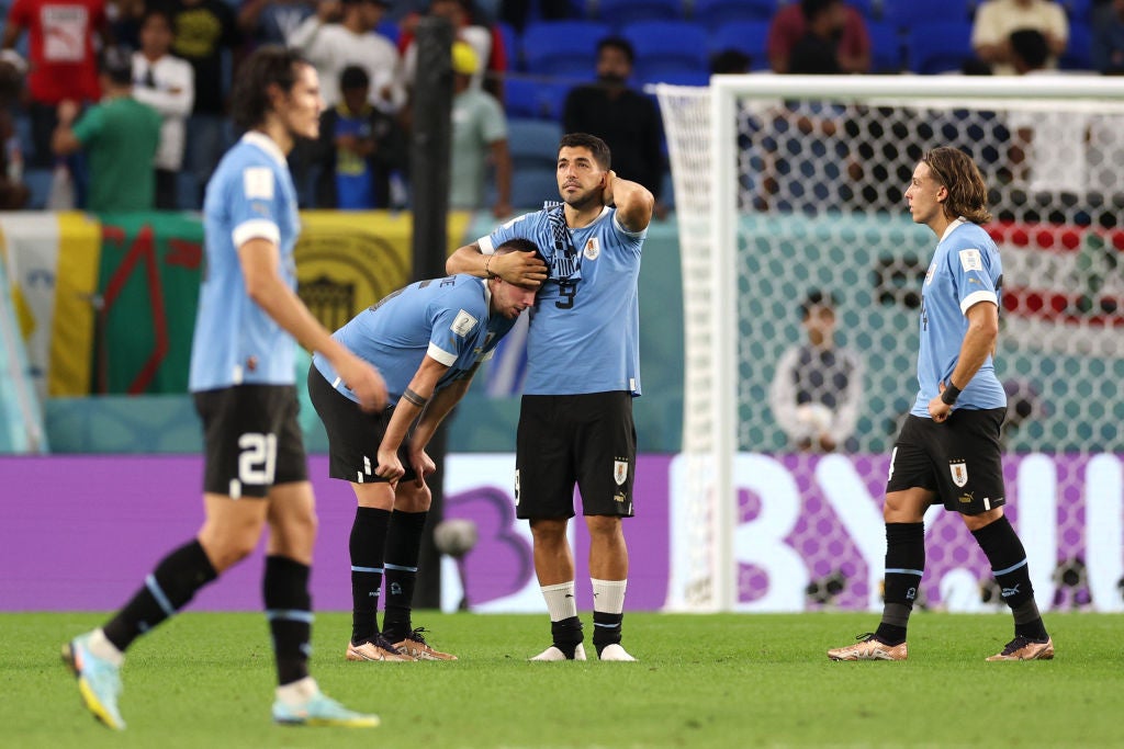 Suarez, centre right, was dejected at the final whistle in what could be his last World Cup game